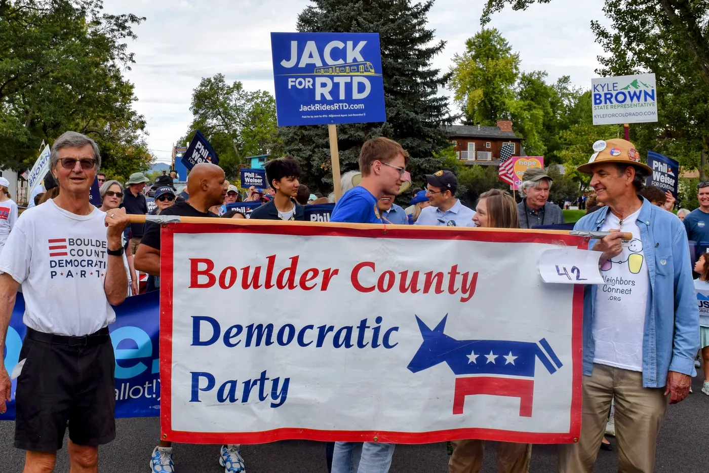 Jack marching behind the Boulder County Democratic Party banner