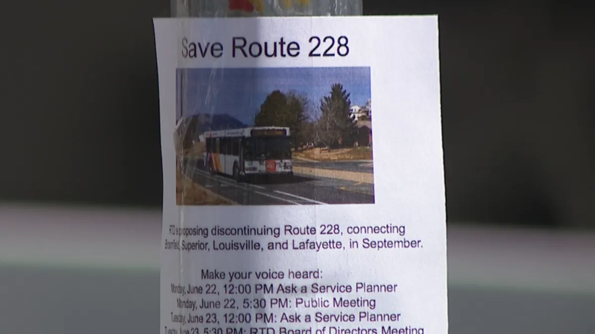 A Save Route 228 flyer posted at a bus stop