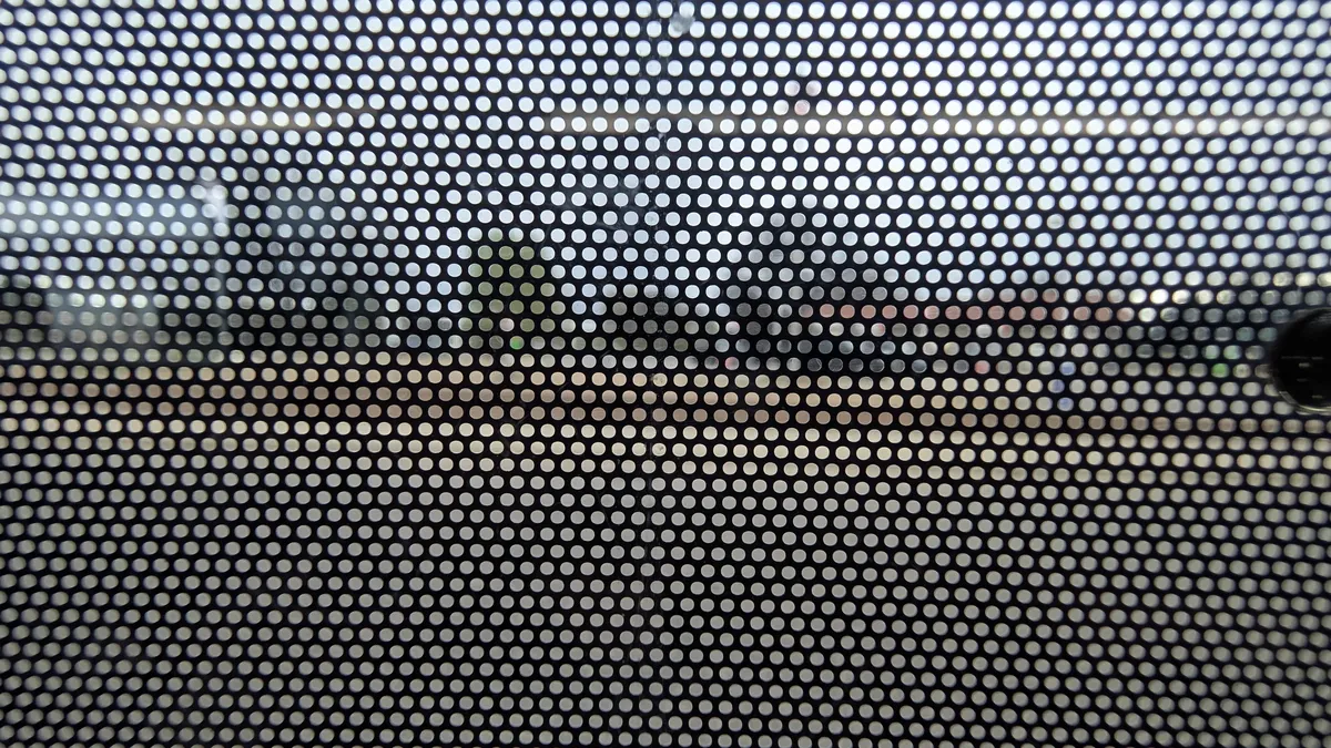 The view through an ad wrap covering an RTD bus window