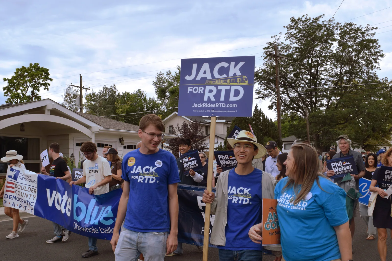 Jack and Bo marching in a Labor Day parade with Jack for RTD signs