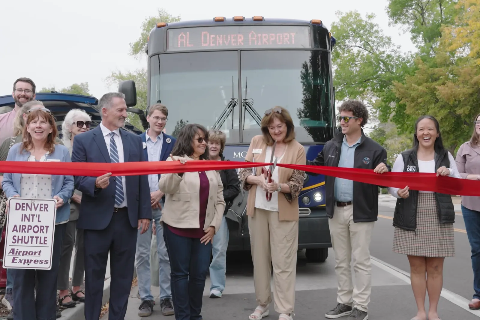 Jack at the ribbon cutting for Route AL, RTD's new airport bus, in front of the bus